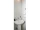 Simple bathroom with pedestal sink and white walls at 10860 Lyric St, Lone Tree, CO 80134