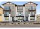Modern two-story townhome with gray siding, balconies, and a landscaped front yard at 10860 Lyric St, Lone Tree, CO 80134