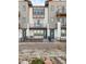 Contemporary townhome with gray siding, balconies, and a black fence at 10860 Lyric St, Lone Tree, CO 80134
