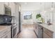 Open concept kitchen with white cabinets and hardwood floors at 10860 Lyric St, Lone Tree, CO 80134