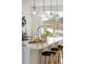 Kitchen island with seating, stainless steel appliances, and sleek pendant lighting at 10860 Lyric St, Lone Tree, CO 80134