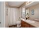 Well-lit bathroom with a single vanity, framed mirror, and shower-tub combination at 10505 Wheeling St, Commerce City, CO 80022