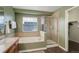 Well-maintained bathroom with a separated tub and glass shower, complemented by tile flooring at 10505 Wheeling St, Commerce City, CO 80022