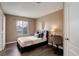Cozy bedroom featuring wood floors, a comfortable bed, and a functional desk area at 10505 Wheeling St, Commerce City, CO 80022