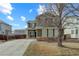 Charming two-story home featuring a stone facade, well-manicured lawn, and a spacious driveway at 10505 Wheeling St, Commerce City, CO 80022