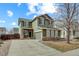 Charming two-story home with green siding, stone accents, and a well-manicured front yard at 10505 Wheeling St, Commerce City, CO 80022