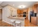 This kitchen features wooden cabinetry, granite countertops, a breakfast bar and stainless steel appliances at 10505 Wheeling St, Commerce City, CO 80022