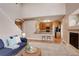 Bright, open concept showcasing a cozy living room with fireplace adjacent to the kitchen at 10505 Wheeling St, Commerce City, CO 80022