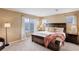 Comfortable main bedroom featuring a large window with blind, and a king size bed at 10505 Wheeling St, Commerce City, CO 80022