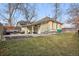 Backyard showcasing a stone patio with outdoor seating and a well-maintained lawn at 3907 S Lincoln St, Englewood, CO 80113