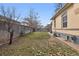 A cozy backyard featuring a wooden fence, a bench, and a combination of grass and fallen leaves at 3907 S Lincoln St, Englewood, CO 80113