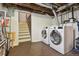 Basement laundry area featuring modern washer and dryer units at 3907 S Lincoln St, Englewood, CO 80113