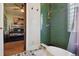 Modern bathroom features a green tiled shower with gold fixtures and a bedroom view at 3907 S Lincoln St, Englewood, CO 80113