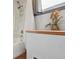 Bathroom featuring a bathtub with shower, wood trim, and decorative accents at 3907 S Lincoln St, Englewood, CO 80113