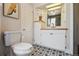 Bright bathroom featuring tiled floor, built-in storage, white vanity and a framed mirror at 3907 S Lincoln St, Englewood, CO 80113