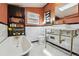 Bathroom featuring a standalone tub, marble walls, brass fixtures, and vanity at 3907 S Lincoln St, Englewood, CO 80113