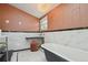 Stylish bathroom featuring a standalone tub, marble walls, stool, and chandelier at 3907 S Lincoln St, Englewood, CO 80113