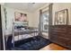 Cozy bedroom featuring natural light, hardwood floors, and soft textures, creating a serene and comfortable retreat at 3907 S Lincoln St, Englewood, CO 80113