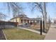 View of the home's exterior with a well-maintained lawn and a classic fence at 3907 S Lincoln St, Englewood, CO 80113