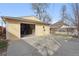 A detached garage with an open door, offering a glimpse of the spacious interior at 3907 S Lincoln St, Englewood, CO 80113