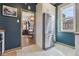 Kitchen with stainless steel refrigerator, white cabinets, and view to dining and living area at 3907 S Lincoln St, Englewood, CO 80113