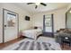 Cozy living space with a bed, sofa, television, area rug, and bright natural light at 3907 S Lincoln St, Englewood, CO 80113