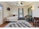 Comfortable living room with a plush sofa, a bed, a ceiling fan, and stylish décor at 3907 S Lincoln St, Englewood, CO 80113