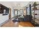 Bright living room features hardwood floors, stylish furniture, and natural light, creating a welcoming and modern space at 3907 S Lincoln St, Englewood, CO 80113
