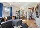 Bright living room with hardwood floors, a stylish couch, and loft access at 3907 S Lincoln St, Englewood, CO 80113
