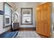 Sunlit room with hardwood floors, large windows, decorative mirror, and treadmill at 3907 S Lincoln St, Englewood, CO 80113