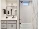 Stylish bathroom with gray vanity, black fixtures, and tiled shower at 4025 Jason St # 101, Denver, CO 80211