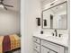 Elegant bathroom with modern vanity and a glimpse of the bedroom at 4025 Jason St # 101, Denver, CO 80211