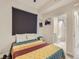 Cozy bedroom with window shade, opening into a bright en-suite bathroom at 4025 Jason St # 101, Denver, CO 80211
