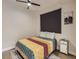 Comfortable bedroom with a colorful quilt and a modern nightstand at 4025 Jason St # 101, Denver, CO 80211
