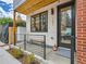 Inviting front porch with modern railings, wooden bench, and flowerbed leading to the front door at 4025 Jason St # 101, Denver, CO 80211