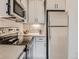 Bright kitchen featuring stainless steel appliances and sleek white cabinetry at 4025 Jason St # 101, Denver, CO 80211