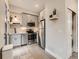 Modern kitchen with stainless steel appliances, light gray cabinets, tile backsplash, and wood floors at 4025 Jason St # 101, Denver, CO 80211