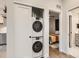 Efficient stacked washer and dryer within a closet, complemented by modern interiors at 4025 Jason St # 101, Denver, CO 80211