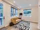 Bright living room with hardwood floors, modern rug, and large windows offering natural light at 4025 Jason St # 101, Denver, CO 80211
