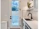 Stylish mud room with modern sink, faucet, and door to the backyard at 4025 Jason St # 101, Denver, CO 80211