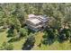 Aerial view of a stunning home with metal roof surrounded by lush, mature trees at 5073 N Lariat Dr, Castle Rock, CO 80108
