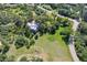 Aerial view of a house with open land and mature trees in a desirable neighborhood at 5073 N Lariat Dr, Castle Rock, CO 80108