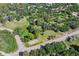 Aerial view showing surrounding neighborhood with large lots, mature trees, and winding roads at 5073 N Lariat Dr, Castle Rock, CO 80108