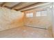 Finished basement featuring wood beam ceiling and wood paneling at 5073 N Lariat Dr, Castle Rock, CO 80108