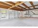 Finished basement with exposed wood beams, large windows, built-in shelving, and a wet bar at 5073 N Lariat Dr, Castle Rock, CO 80108