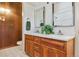 Bathroom features a double sink vanity with modern faucets, mirrors, wooden cabinets, and a toilet at 5073 N Lariat Dr, Castle Rock, CO 80108
