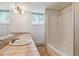 Well-lit bathroom with large vanity, double sinks, and shower-tub combo at 5073 N Lariat Dr, Castle Rock, CO 80108