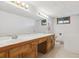 Bathroom with double sink vanity, ample counter space, and well-lit mirror at 5073 N Lariat Dr, Castle Rock, CO 80108