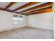Bright bedroom with wood beam ceiling, large windows providing natural light at 5073 N Lariat Dr, Castle Rock, CO 80108