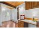 Entry area features a built-in desk space, wood flooring, and a front door with sidelight window at 5073 N Lariat Dr, Castle Rock, CO 80108